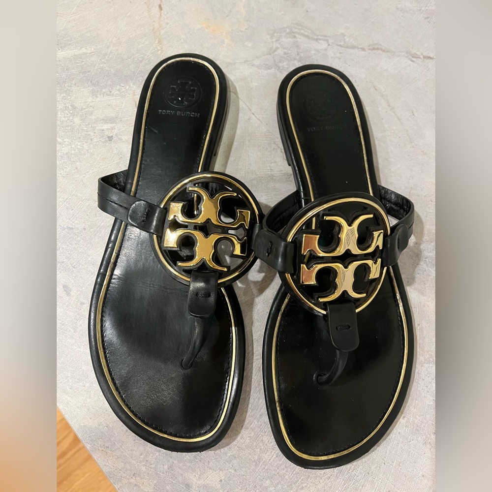 Well loved Tory Burch leather and gold flip flops